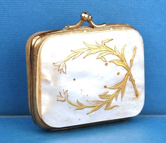 A French porte-monnaie made of mother-of-pearl, with brass and silver inlay. From Pinterest.