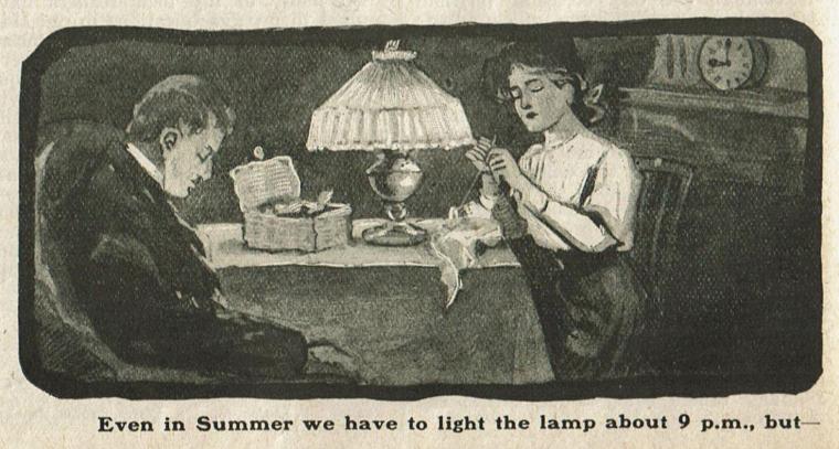 A man and woman sit at a table in a darkened room. The woman is sewing under a single lamp on the table. In the background a clock on a mantel shows the time is nine o'clock.