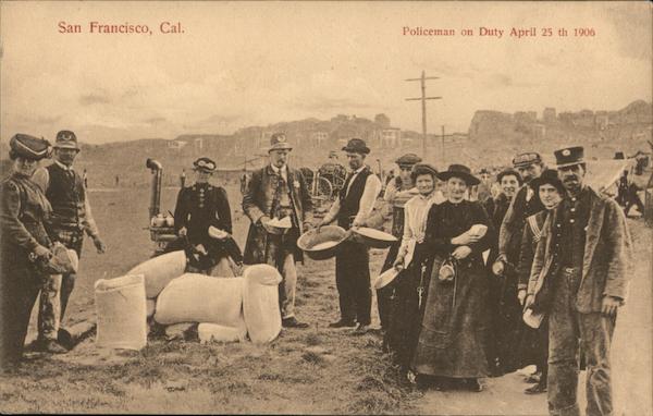 In an open field police officers and a group of people stand beside large white sacks of flour. One policeman holds a small bowl in which are white packets; beside him is a man holding out a large bowl to receive the packets. Other people in the photo are also holding out bowls. One woman and one man are holding small packets they have already received.