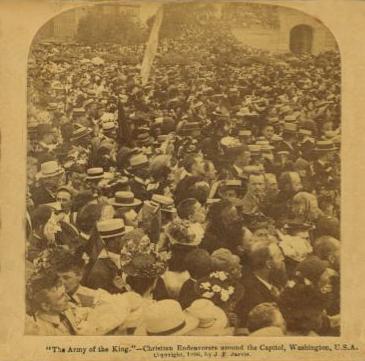 Sepia photo of a crowd of people packed tightly together.