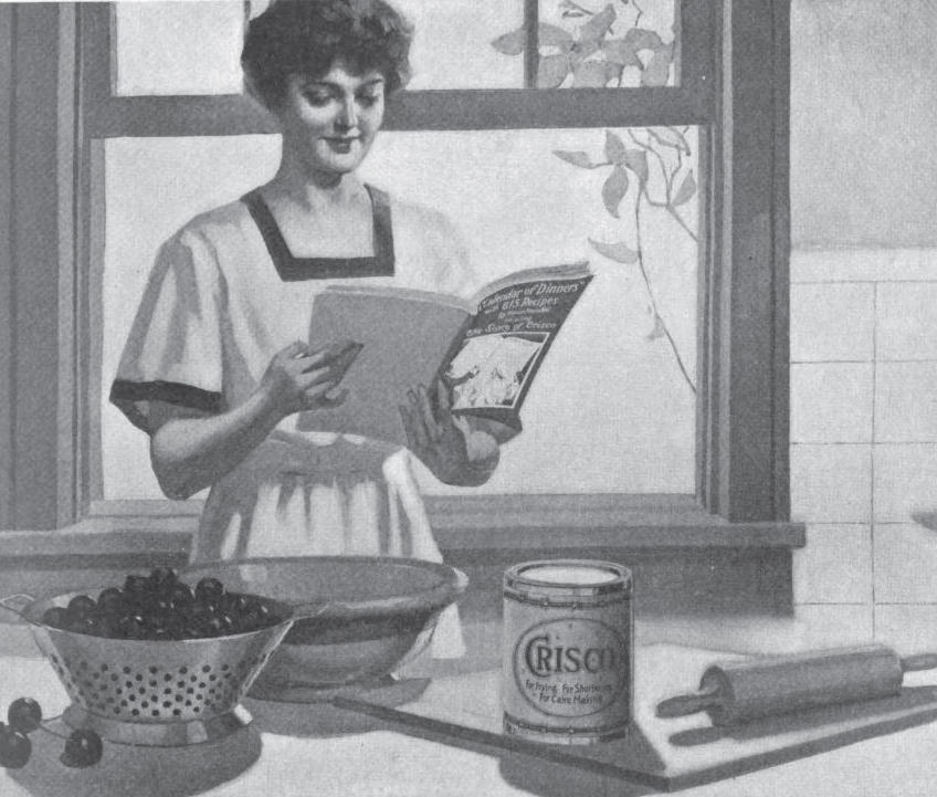 Illustration of a woman reading a cookbook in her kitchen about 1920. On the table before her is a colander full of berries, a large empty bowl, a can of Crisco and a rolling pin.  